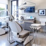 a modern dental office equipped with advanced technology showcases a confident patient smiling with dental implants, highlighting the contrast between the sleek, sterile environment and the natural appearance of their new teeth.