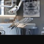 a sleek dental clinic interior showcases a confident patient seated in an elegant dental chair, with a focused dentist explaining the intricate details of a titanium dental implant model, illuminated by precise artificial lighting for a professional atmosphere.