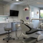 a sleek, modern dental clinic in lake worth, showcasing a state-of-the-art dental implant setup with a professional, focused dentist discussing treatment options with a patient in a bright, carefully designed consultation room.