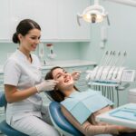 Dental check-up scene with a dentist and patient discussing dental implants