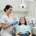 Dental consultation for veneers in a modern clinic with a smiling patient and dentist