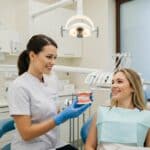 Dental consultation scene showcasing a patient and dentist discussing dental implants in a bright clinic
