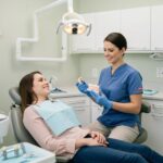 Dental consultation scene showcasing a patient discussing dental implants with a dentist, highlighting confidence and care