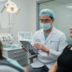 Dental implant surgeon consulting with a patient in a modern clinic