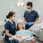Dental surgery setting with dentist and patient discussing procedures