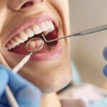a clinical dental office setting features a close-up of a smiling patient in a dental chair, showcasing pristine, healthy gums while a dentist examines dental implants under bright, focused lighting, highlighting the crucial connection between gum health and successful dental procedures.