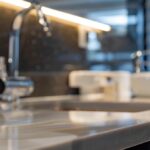 a sleek dental clinic interior features a close-up of a modern dental implant displayed on an elegant, polished countertop, showcasing its lifelike texture and color in a well-lit, professional setting.