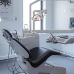 a sleek, modern dental clinic in mansfield, featuring an expert oral surgeon delicately adjusting advanced dental implant technology in a bright, sterile treatment room designed for patient comfort and precision.