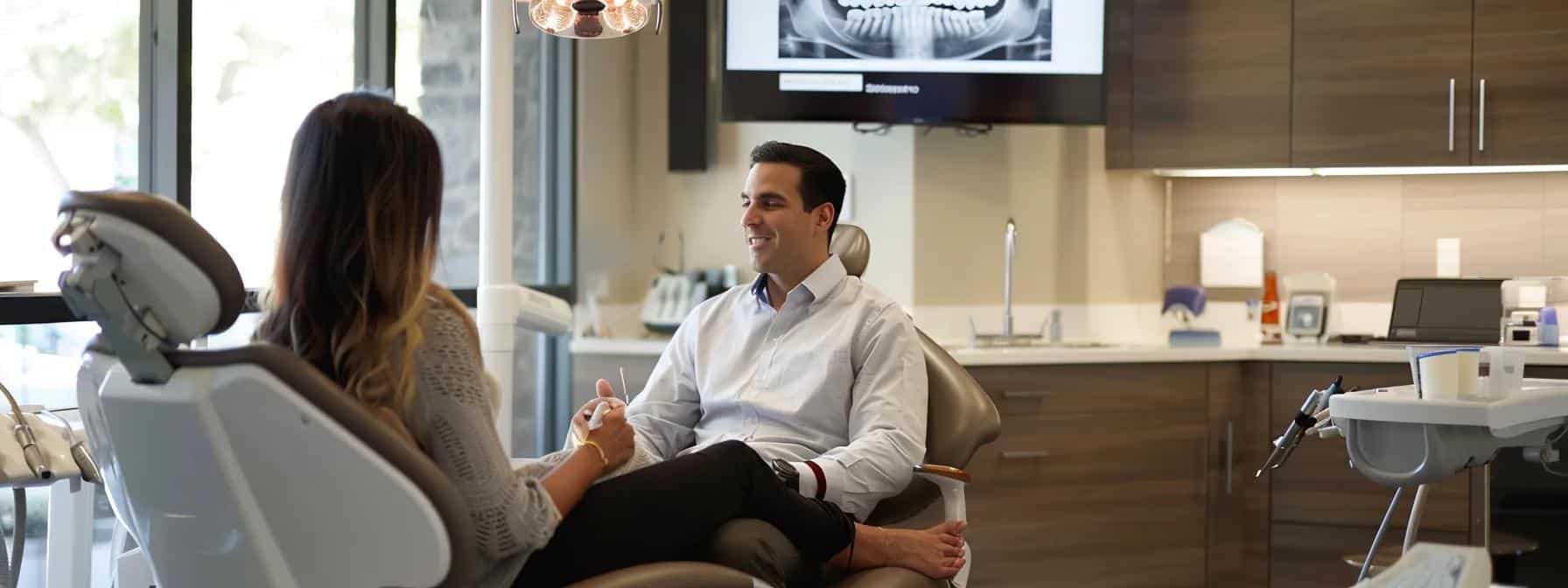 a warm and inviting dental office setting features a compassionate dentist engaging with a nervous patient, showcasing a modern, well-lit environment that emphasizes comfort and trust during the dental implant consultation.
