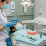 Patient receiving post-operative care instructions for dental implants in a calm dental clinic