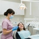 Smiling patient consulting with a dentist about dental veneers in a modern dental clinic