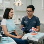 Dental consultation about implant timeline with a patient in a modern dental office