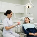 Dental consultation scene with a patient and dentist discussing dental implants in a modern clinic