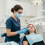 Dental professional discussing dental implant aftercare with a patient in a modern clinic