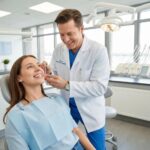 Dental professional discussing dental implants and dentures with a patient in a modern clinic