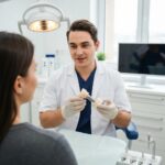 Dental professional discussing dental implants with a patient in a modern clinic