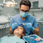 Dental professional examining a dental implant in a clinical setting