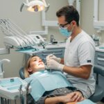 Dental professional performing immediate dental implant procedure in a clinical setting