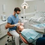 Dental professional performing immediate dental implant procedure in a clinical setting