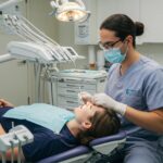 Dental professional performing immediate dental implant procedure in a modern clinic