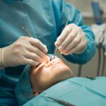 Dental professional performing immediate dental implant surgery in a modern clinic
