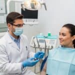 Dental implant surgery procedure with dentist and patient in a clinical setting