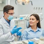 Dental implant procedure with dentist and patient in a clinical setting