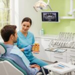 Dental professional discussing root canal therapy with a patient in a welcoming dental office
