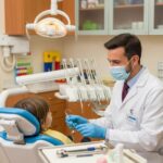 Pediatric dentist engaging with a child in a colorful dental office, highlighting emergency dental services for kids