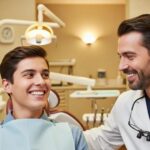 Smiling person in a dental office, showcasing the benefits of dental implants