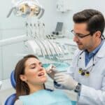 Dental professional discussing mini dental implants with a patient in a modern clinic