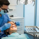 Dental professional examining a patient for dental implants in a modern clinic