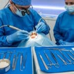 Dental professional performing a bone grafting procedure in a modern clinic