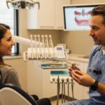 Smiling patient in a dental clinic discussing dental implants with a dentist