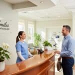 Welcoming dental clinic reception with a friendly professional and patient interaction