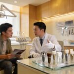 Dental professional consulting with a patient about dental implants in a modern clinic